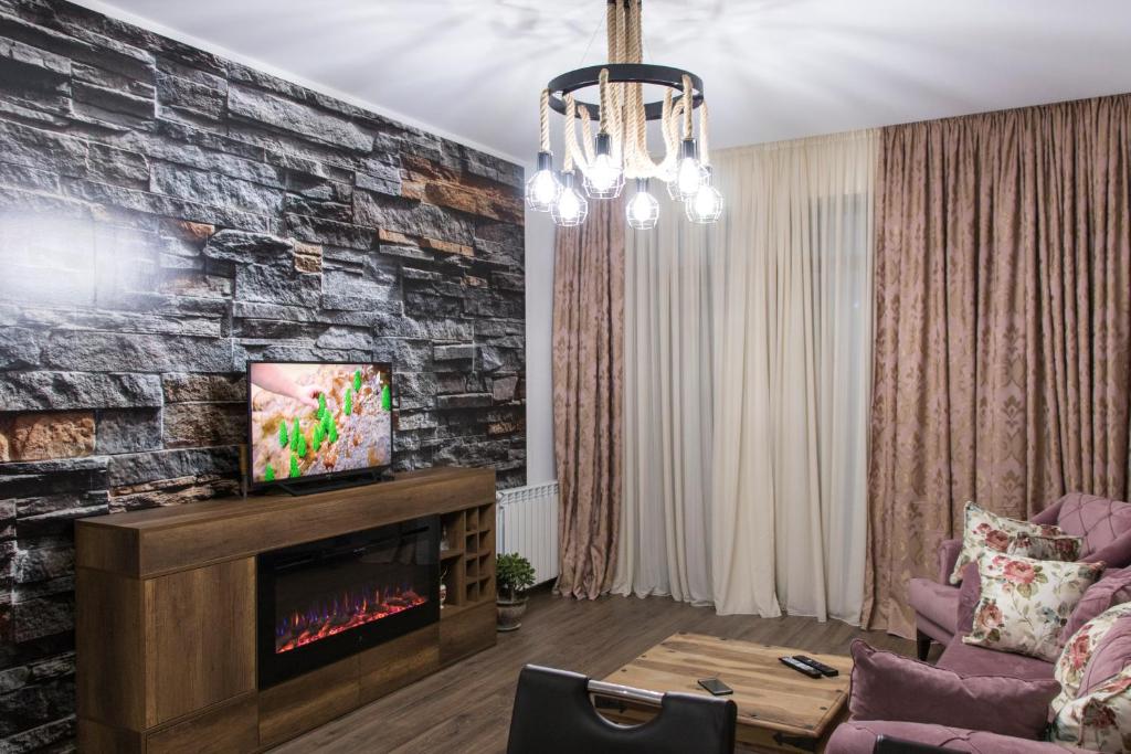 a living room with a fireplace and a tv at 7th HEAVEN Apartment in Central Tbilisi in Tbilisi City