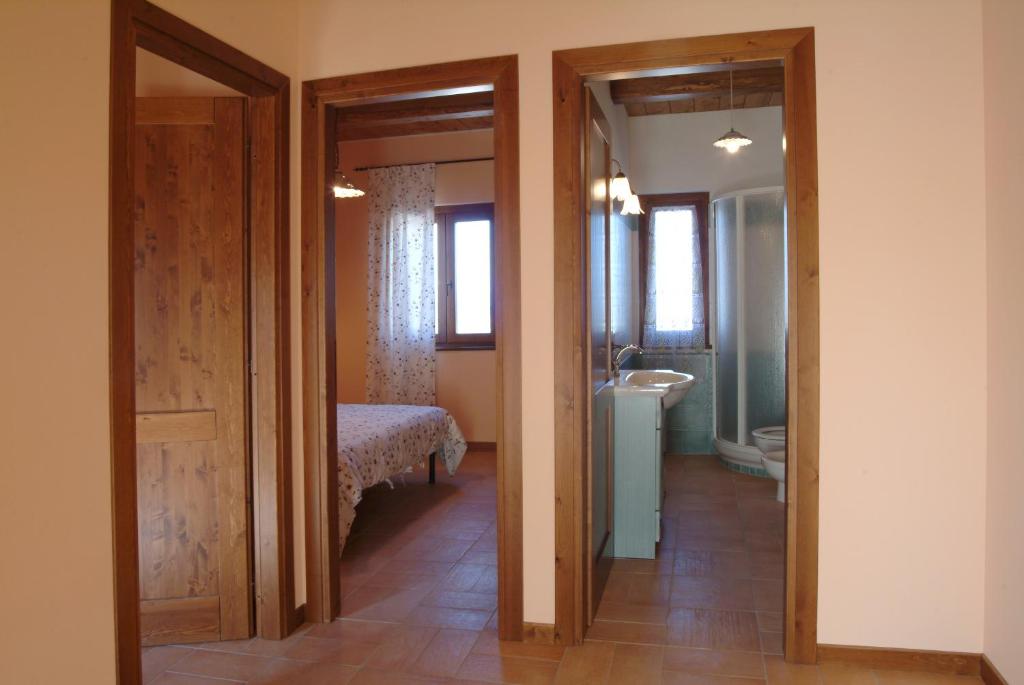 Postel nebo postele na pokoji v ubytování Agriturismo Le Ginestre