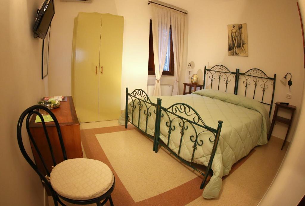 a bedroom with a bed and a chair at Alla Selva Gravina in Gravina in Puglia