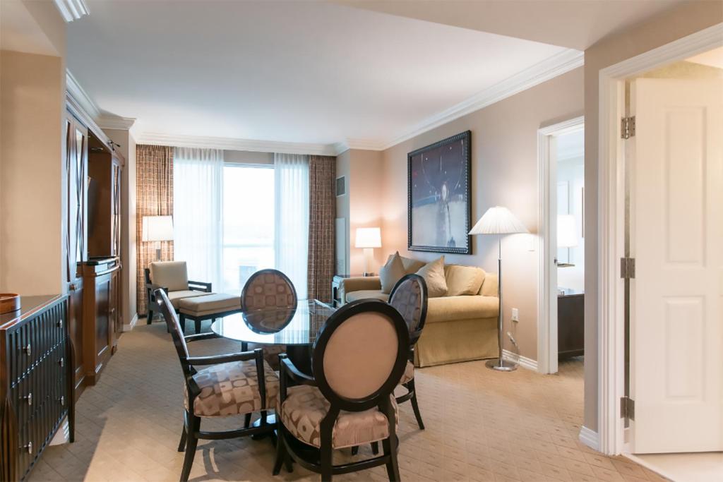 a living room with a table and chairs and a couch at MGM Signature in Las Vegas