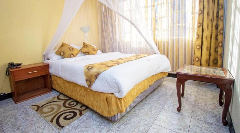 a bedroom with a bed with two teddy bears on it at Hotel Embassy in Nairobi