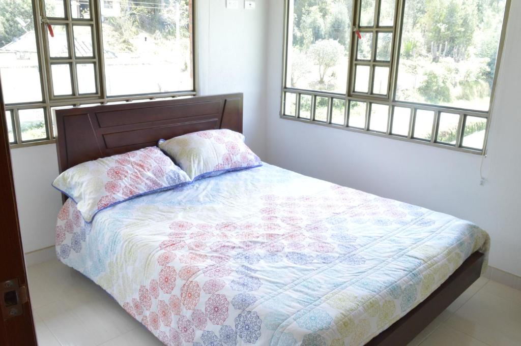 En eller flere senge i et værelse på Villa Libertad