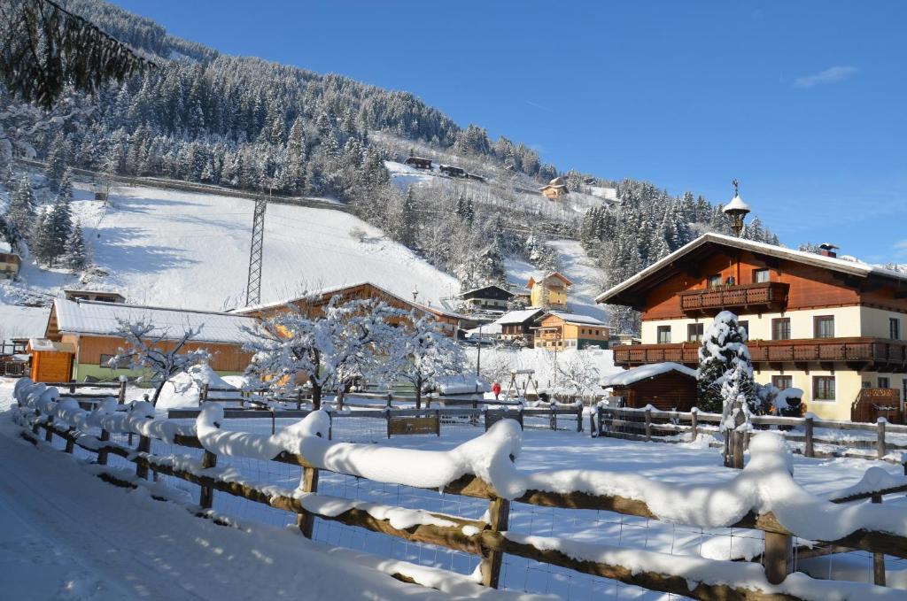 a village covered in snow in front of a lodge at Scheibenhof in Bad Gastein
