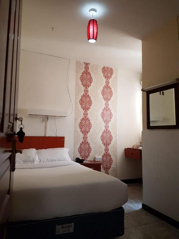 Postel nebo postele na pokoji v ubytování Hotel Embassy