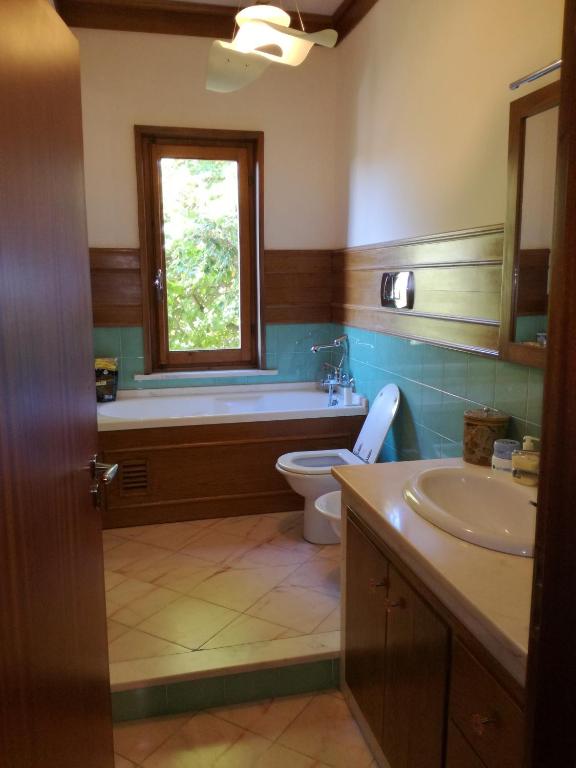 a bathroom with a tub and a toilet and a sink at La casa di Simona in Pistoia