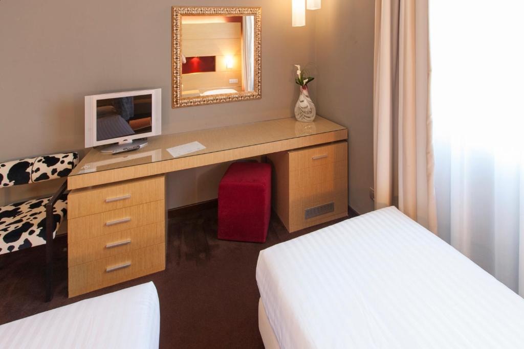 Postel nebo postele na pokoji v ubytování Inverigo Hotel