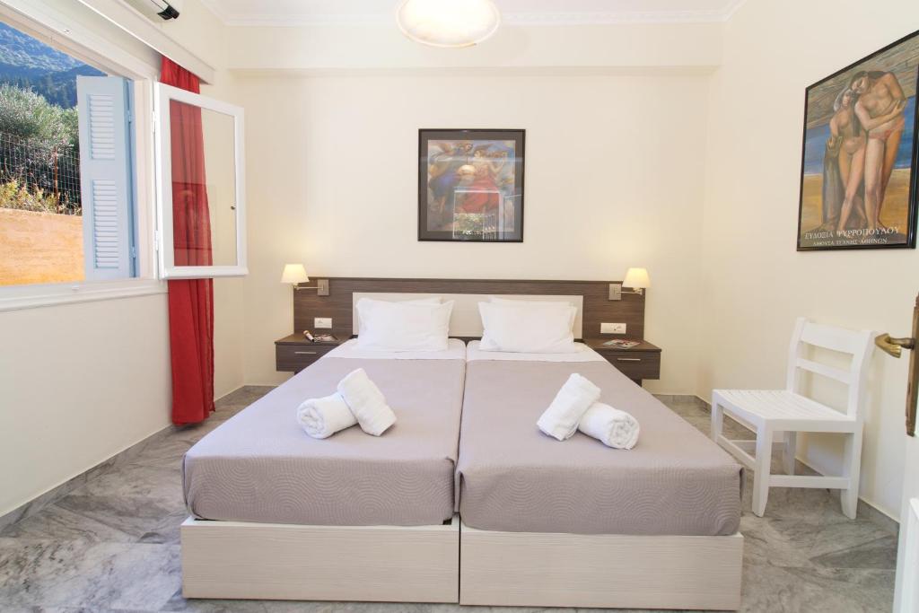 two beds in a bedroom with two pillows at Prince Studios in Sami