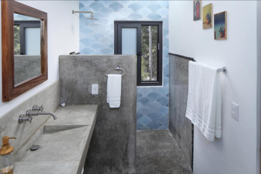 a bathroom with a concrete sink and a shower at Villa Dorado - Duplex in Sayulita