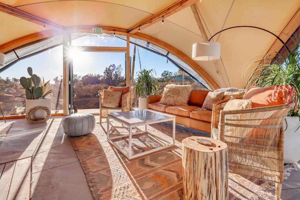 a living room in a dome house with a glass table at Under Canvas Grand Canyon in Valle