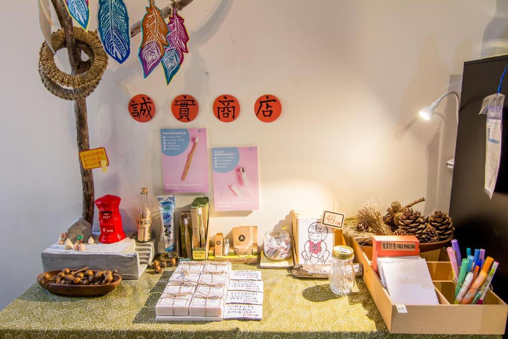 a table with books and other items on it at 日安艸木環境友善民宿 Greener Homestay in Taitung City