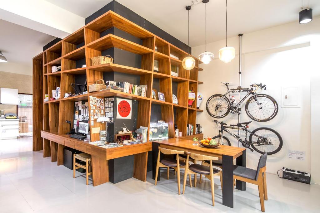 a dining room with a table and a bike on the wall at 日安艸木環境友善民宿 Greener Homestay in Taitung City