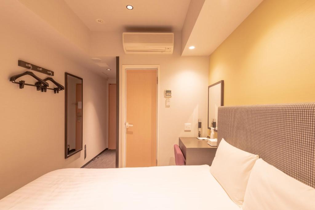 Postel nebo postele na pokoji v ubytování E Hotel Higashi Shinjuku