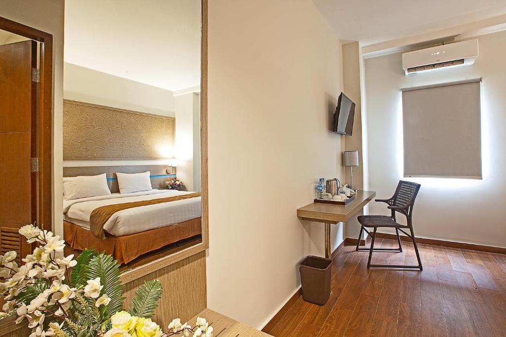 Ένα ή περισσότερα κρεβάτια σε δωμάτιο στο Genio Hotel Manado