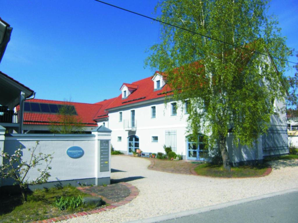 a large white house with a red roof at Hof Hanau in Dörgenhausen