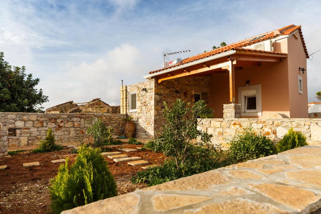 a stone house with a stone wall in front of it at Villa Maria Kythera in Katsoulliánika
