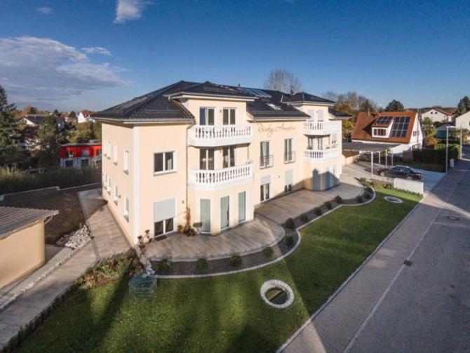 a large white house with a green yard at Ferienparadies Amadeus in Burtenbach