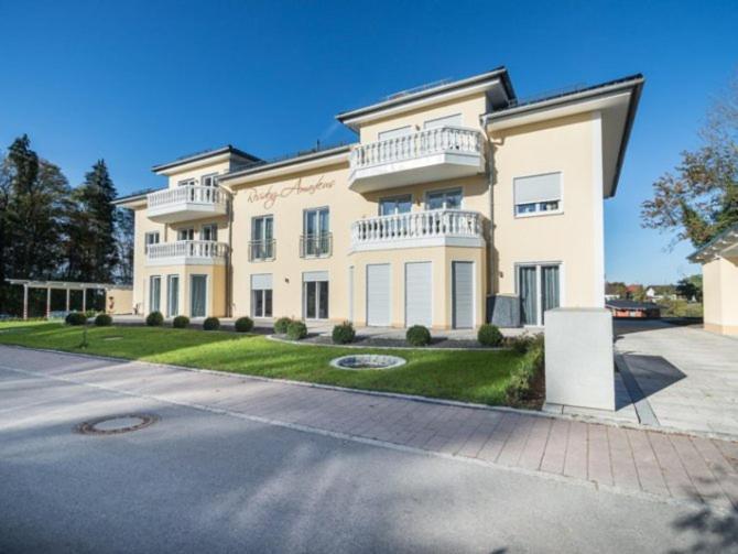 a large white house with a large driveway at Ferienparadies Amadeus in Burtenbach