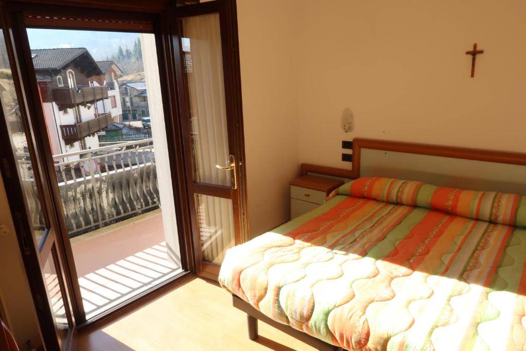 Кровать или кровати в номере Albergo Ristorante Sciatori