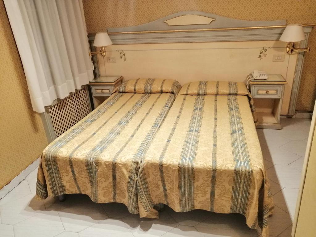Postel nebo postele na pokoji v ubytování Hotel Falier