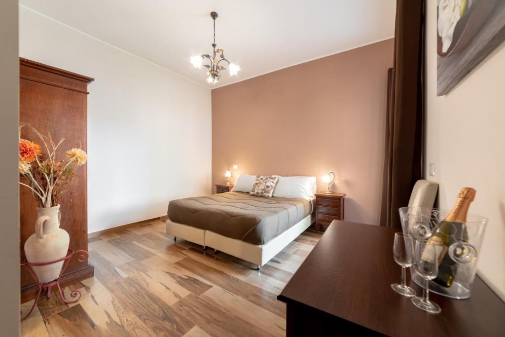a bedroom with a bed and a table in a room at Myricae Rooms Affittacamere in Fiumicino