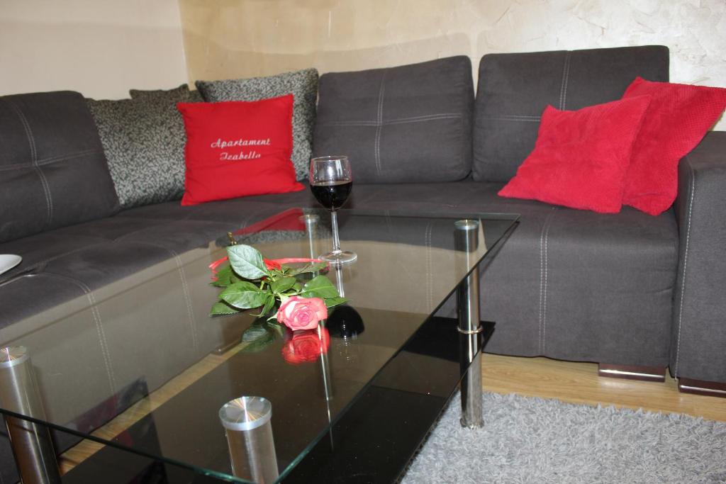 a living room with a couch and a glass table at Apartament Izabella in Suwałki