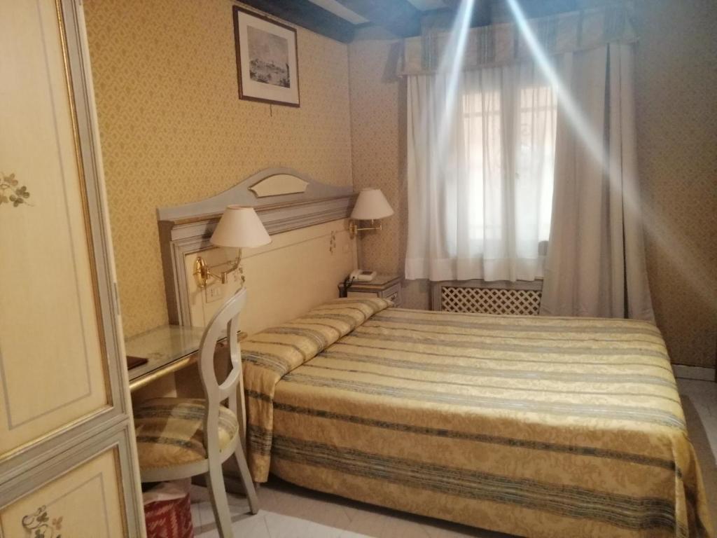 Postel nebo postele na pokoji v ubytování Hotel Falier