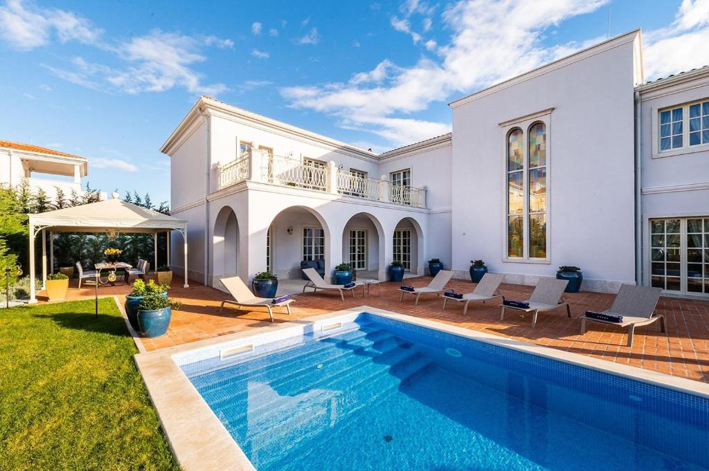 a large white house with a swimming pool at Villa Zara in Vabriga