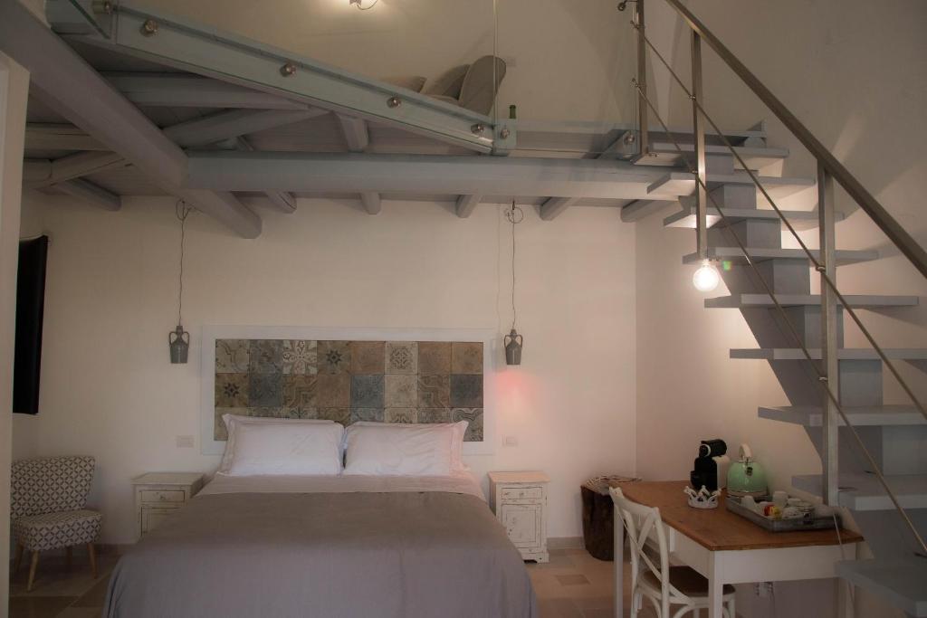 Postel nebo postele na pokoji v ubytování Dimora Del Duca, masseria b&b di charme