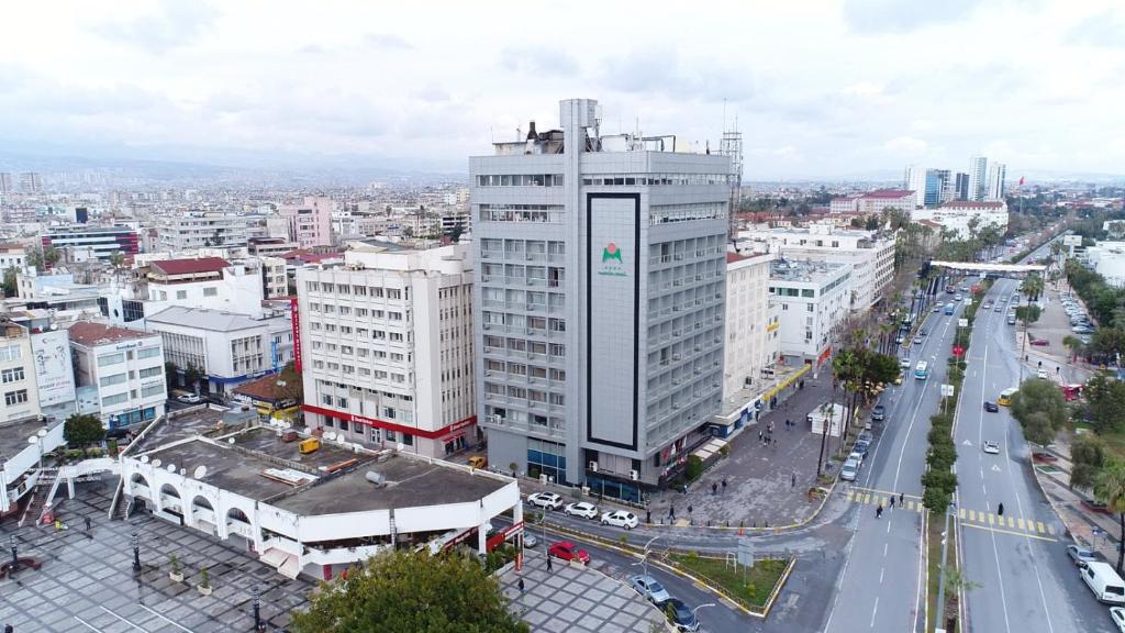 an aerial view of a city with a tall building at Mersin Oteli in Mersin