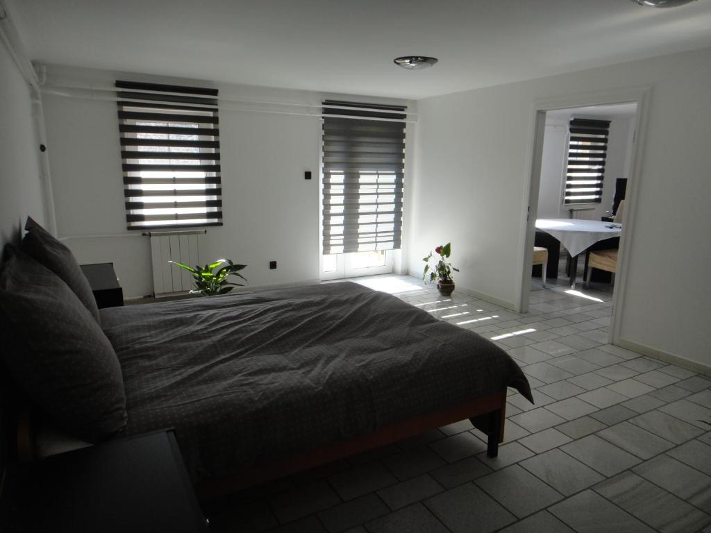 een slaapkamer met een bed, een bureau en een piano bij Liliom in Szeged