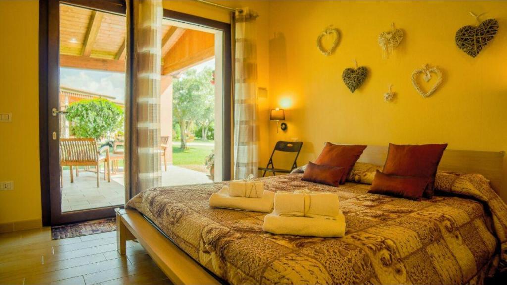 een slaapkamer met een bed met twee handdoeken erop bij B & B La Magia in Iglesias