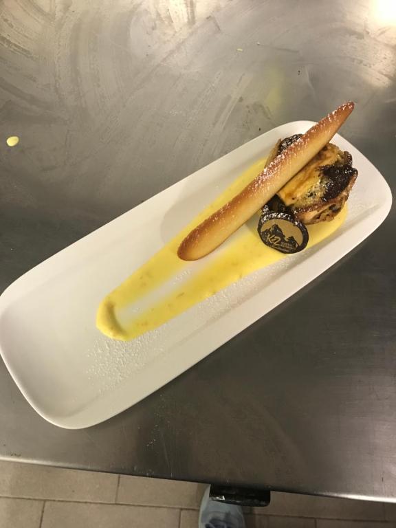 a white plate with two food items on a table at Albergo K2 in Madesimo