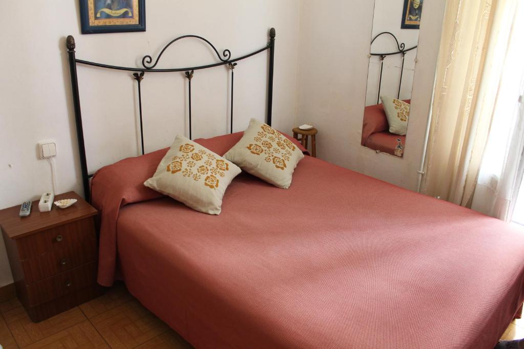 Un ou plusieurs lits dans un hébergement de l'établissement Hostal Graciela