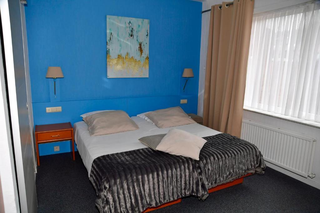 Postel nebo postele na pokoji v ubytování Hotel 'T Hert