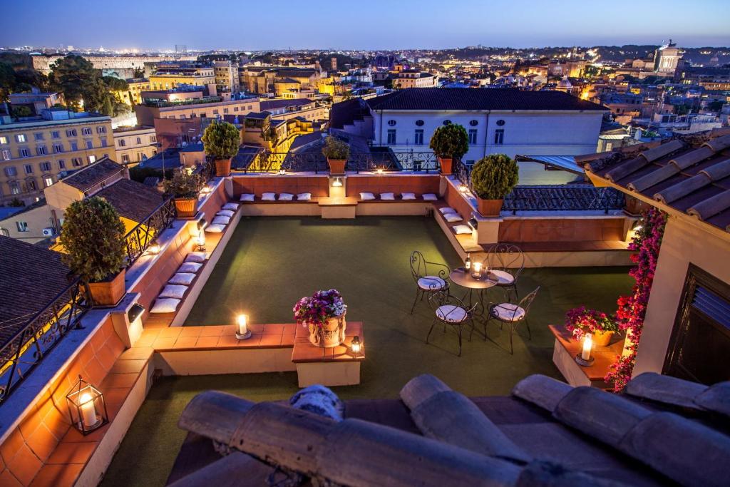 a view of the rooftop of a building with lights at Hotel Colosseum in Rome