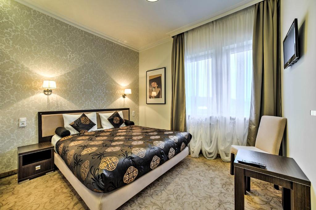 Posteľ alebo postele v izbe v ubytovaní Hotel Luxor
