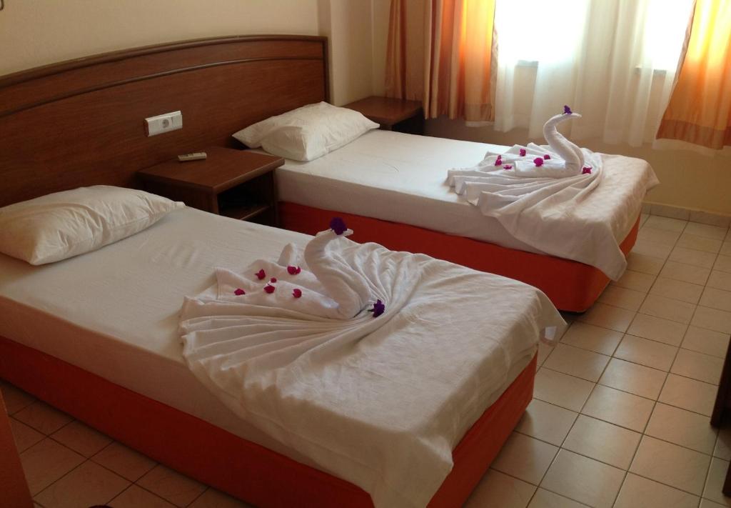 Postel nebo postele na pokoji v ubytování Baronessa Apart Hotel