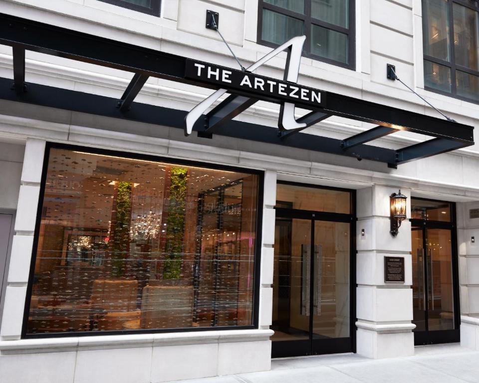 a store front with a sign for the afwegian at Artezen Hotel in New York