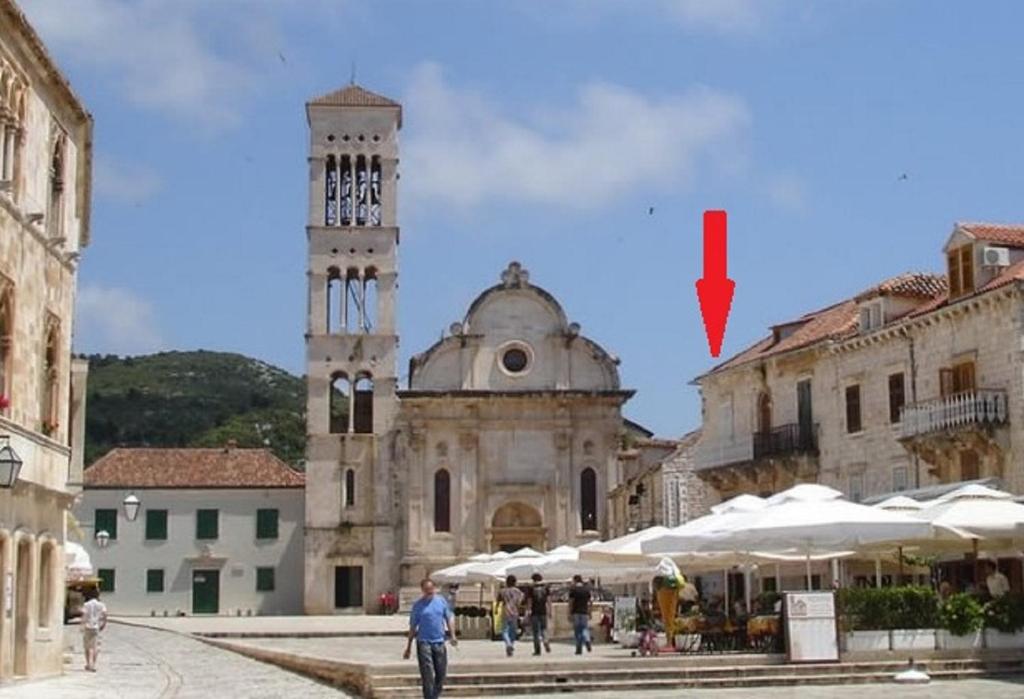 a building with a clock tower in a city at Takoma Hvar in Hvar