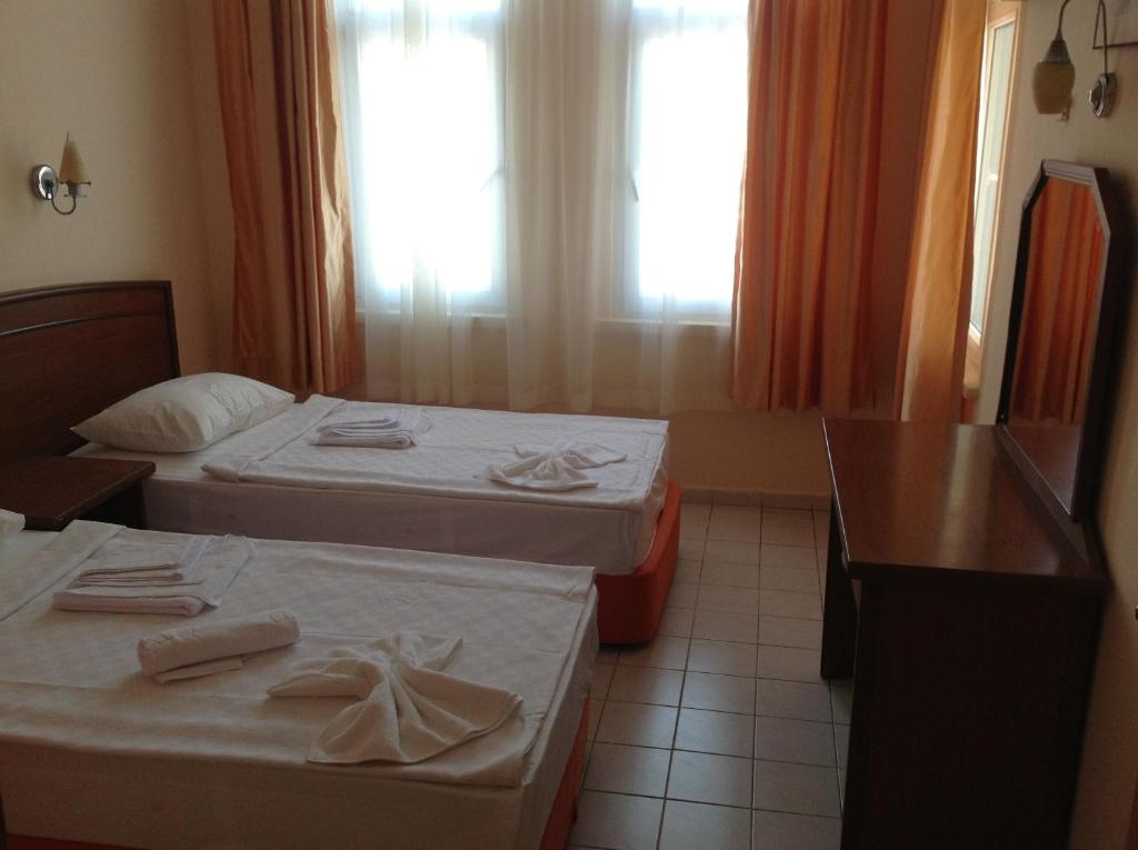 Postel nebo postele na pokoji v ubytování Baronessa Apart Hotel