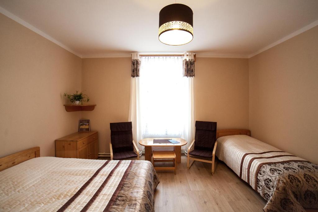 Postel nebo postele na pokoji v ubytování Hotel Pod Zámkem