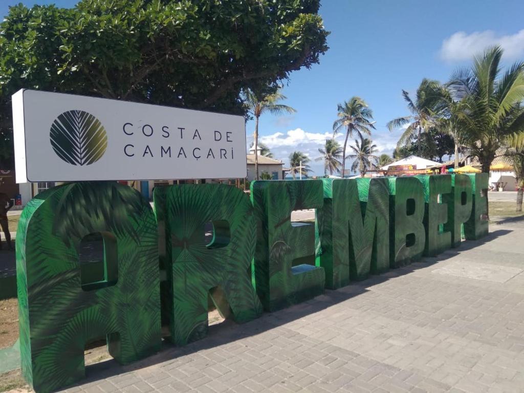 a sign that reads costa becanarcan with green fences at Arembepe in Arembepe