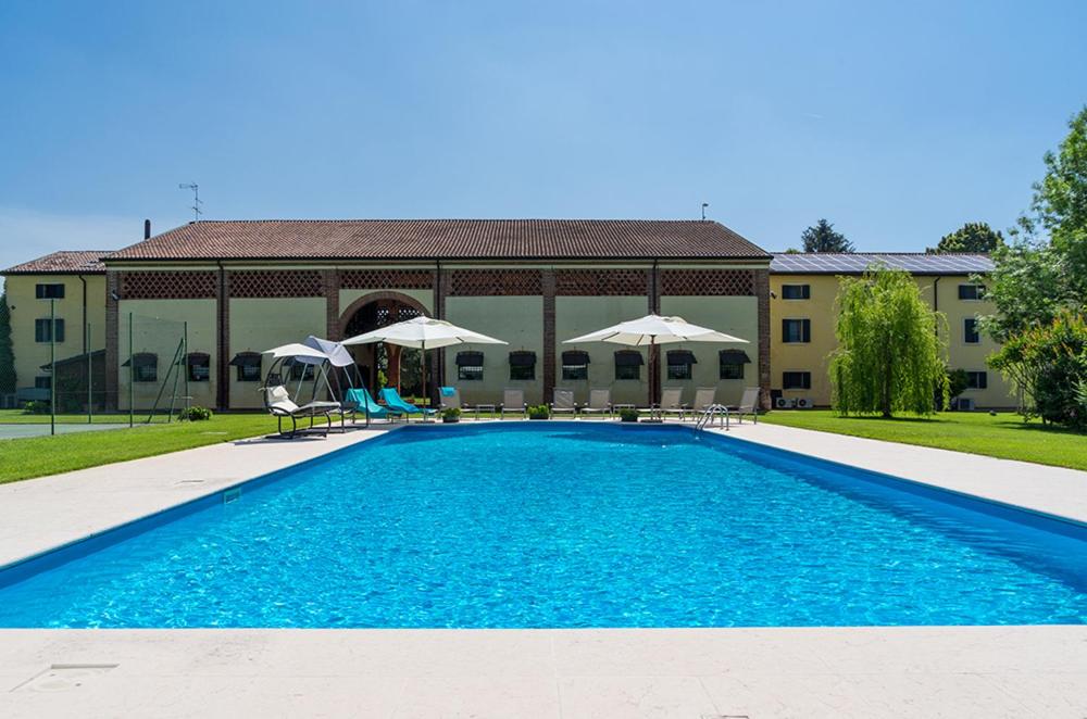 a swimming pool in front of a building at Casa Petra in Vigasio