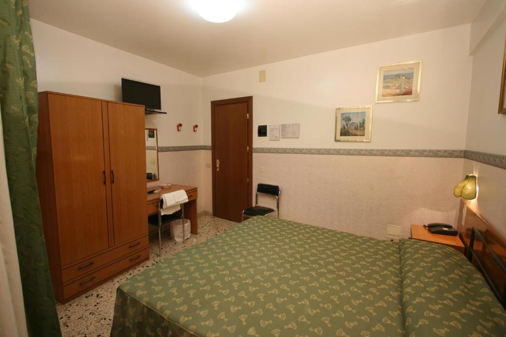 Postel nebo postele na pokoji v ubytování Hotel Cortese