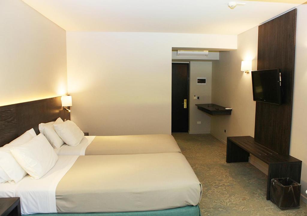 Postel nebo postele na pokoji v ubytování Hotel Bosque de Reñaca
