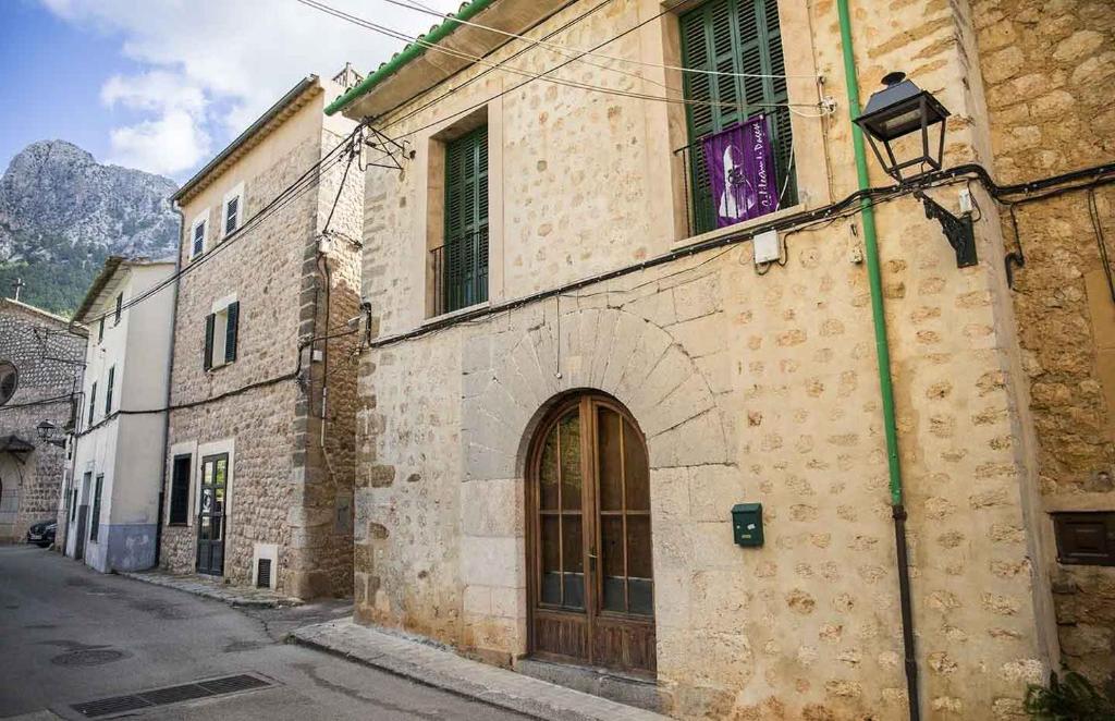 an old stone building with a door on a street at Hiker's TownHouse in Sóller