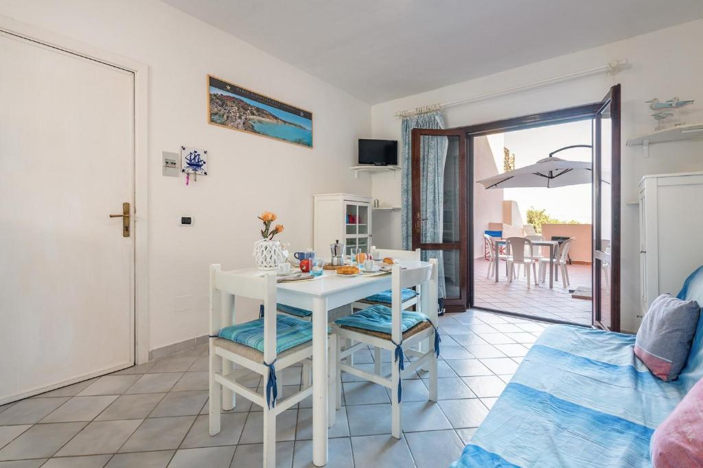 a living room with a white table and chairs at Apartments Stintino - Insel Sardinien 23216 in Villa Sirena