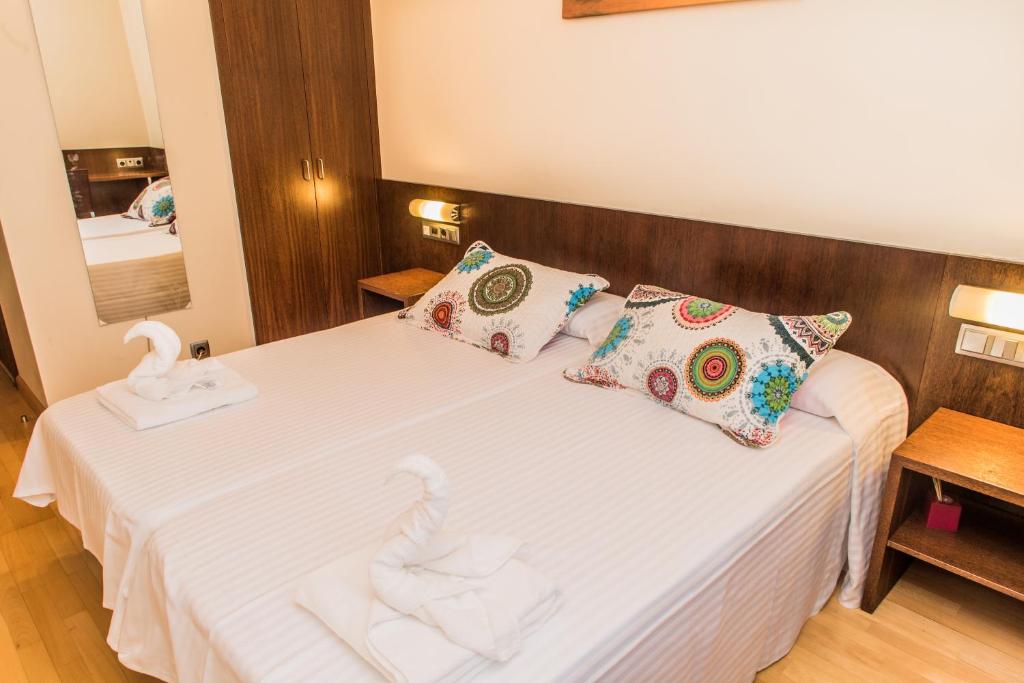 Postel nebo postele na pokoji v ubytování Hostal Nirvana