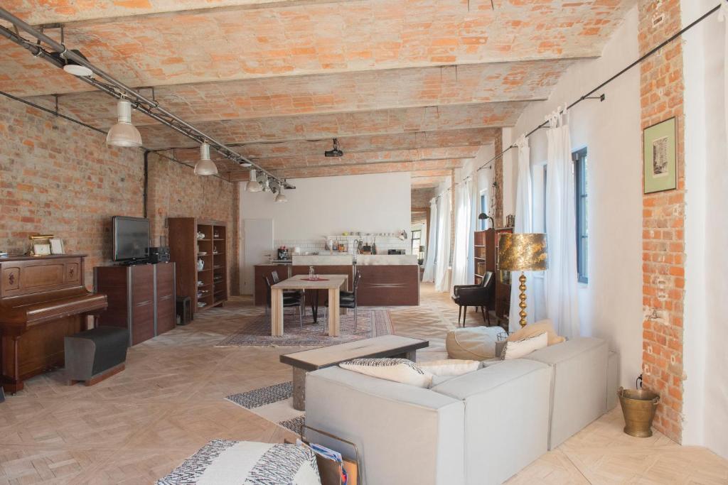 a living room with a couch and a table at Freiraum Loft in Markkleeberg