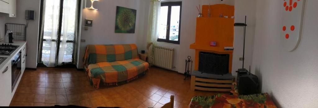 a living room with a couch and a chair in it at Il Capriolo in Piazzatorre